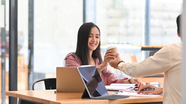 istock Together office man take a coffee to friendly business colleagues. 1216089626