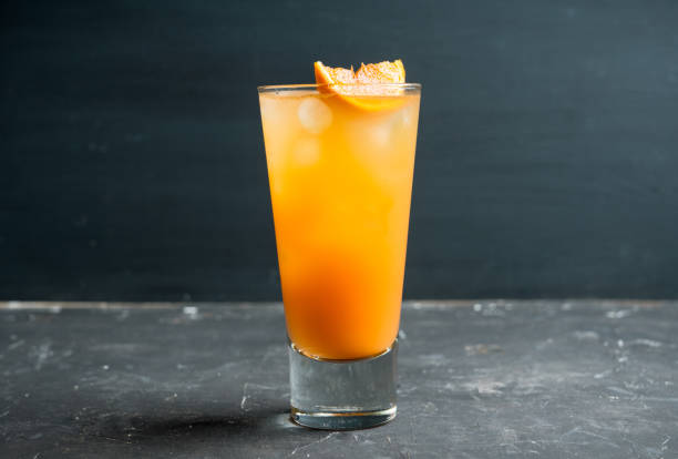 istock Fresh cocktail with vodka and orange juice on the rustic background 1216091371