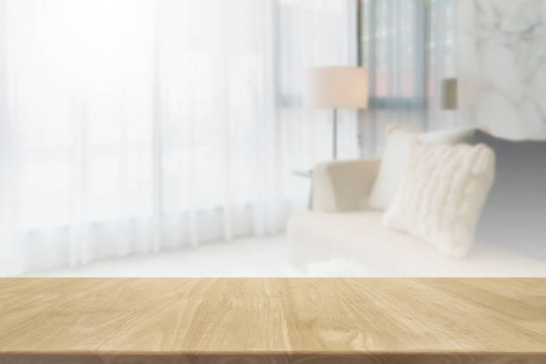 istock Empty wood table top and blurred living room in home interior with curtain window background. - can used for display or montage your products. 1216093370