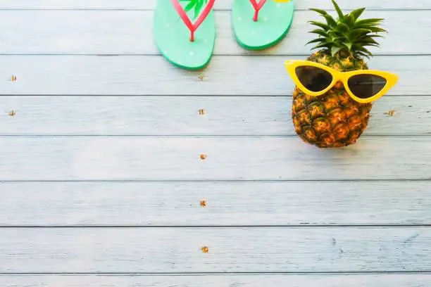 summer holidays vacation concept,pineapple watermelon on wooden background with copy space