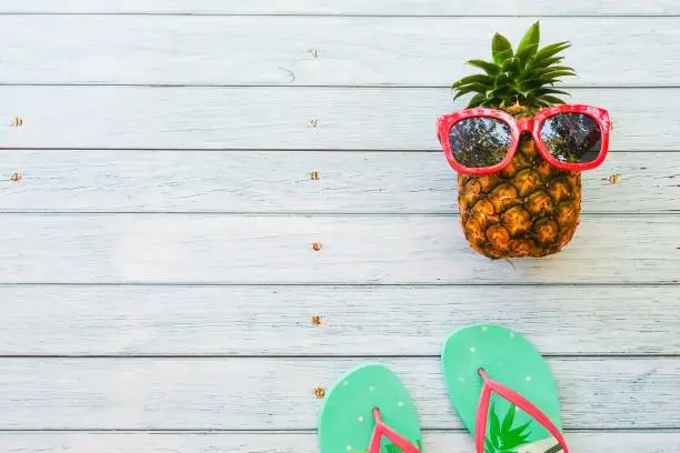 summer holidays vacation concept,pineapple watermelon on wooden background with copy space