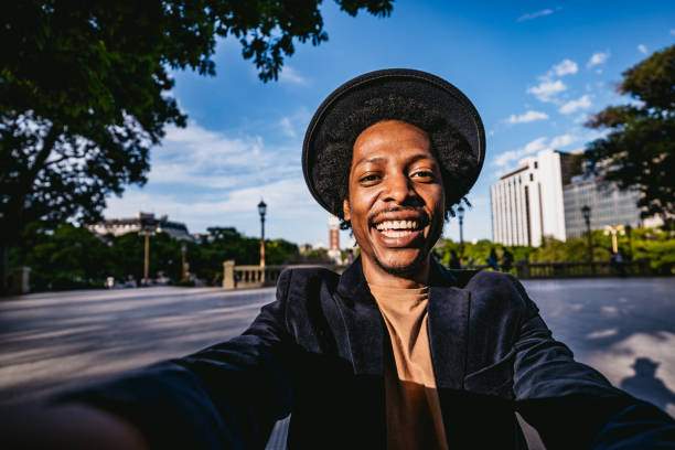 istock Smiling man making selfie in park 1216096872