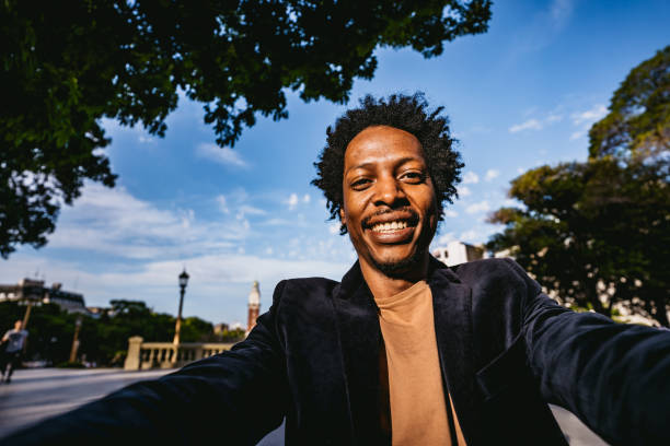 Smiling man making selfie in park Smiling young African man making selfie in public park. selfie madrid photos stock pictures, royalty-free photos & images