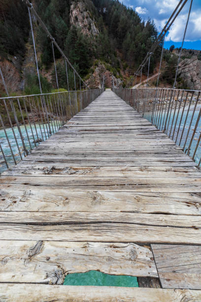 istock suspension bridge over the wild river in spain 1216096943
