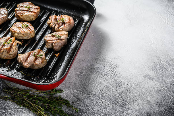 istock Tender boneless grilled pork chops. steak tenderloin. gray background. Top view. Copy space 1216098215