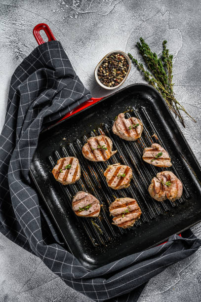 istock Tender boneless grilled pork chops. steak tenderloin. gray background. Top view 1216098325