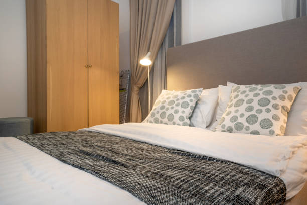 istock queen size bed with bed runner and reading lamp in villa, house and apartment 1216098461