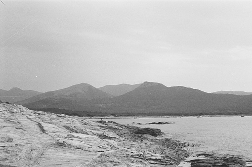 cloudy skies and hills frame a timeless bay