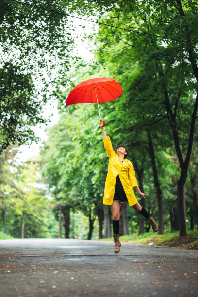 istock Woman in park at rain 1216100099