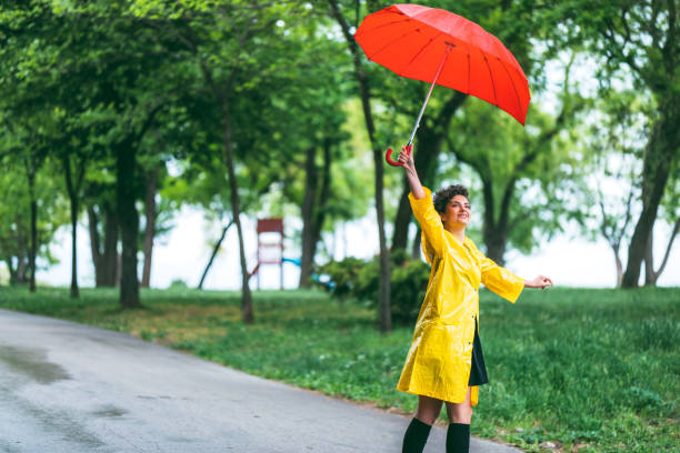 istock Woman in park at rain 1216100123