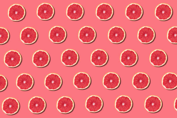 istock Fresh red orange or grapefruit on a peach color background. 1216101220