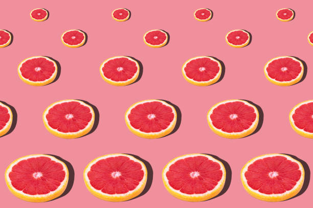 istock Fresh red orange or grapefruit on a peach color background. 1216101222