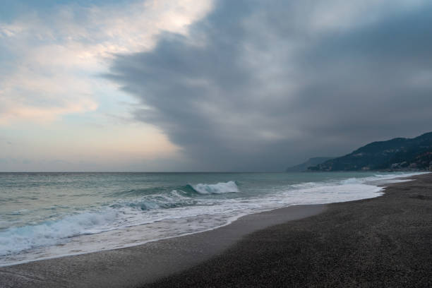 Cloudy day over the Ligurian sea, Italian Riviera Clouds over the sea in soft sunlight in wintertime, Varigotti, Liguria, Italy finale ligure stock pictures, royalty-free photos & images