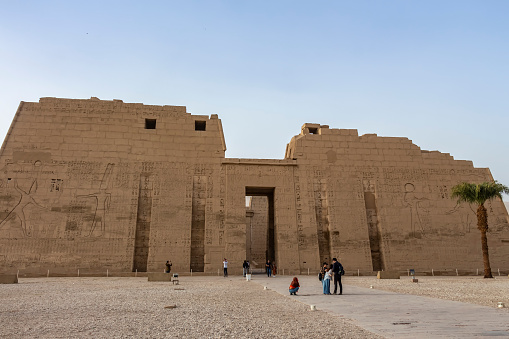 Karnak Temple, Luxor, Egypt - July 21, 2022: The Karnak Temple Complex, commonly known as Karnak  comprises a vast mix of decayed temples, pylons, chapels, and other buildings near Luxor, Egypt. Construction at the complex began during the reign of Senusret I (reigned 1971–1926 BCE) in the Middle Kingdom (around 2000–1700 BCE) and continued into the Ptolemaic Kingdom (305–30 BCE), although most of the extant buildings date from the New Kingdom. \n\nIt is part of the monumental city of Thebes (Luxor), and in 1979 it was inscribed on the UNESCO World Heritage List along with the rest of the city.