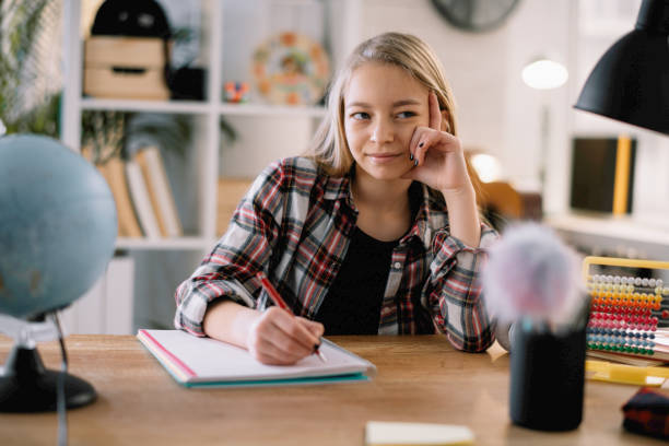 istock Little girl doing homework in home. 1216102923