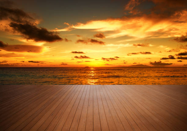 Empty wooden terrace at the seaside with sunset sky nature background