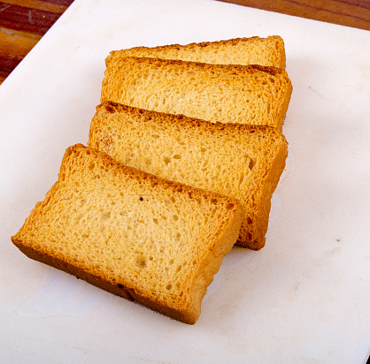 bird's eye view of three loaves of bread, one of which is cut in half and allows you to see the crumb of bread.