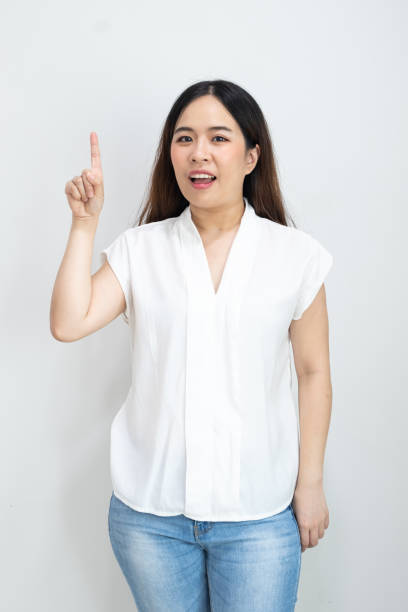 istock Happy Asian Woman with finger point up isolate on white background 1216106517
