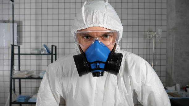 istock Mad doctor in protective suit looking to camera and breathing heavily 1216106909