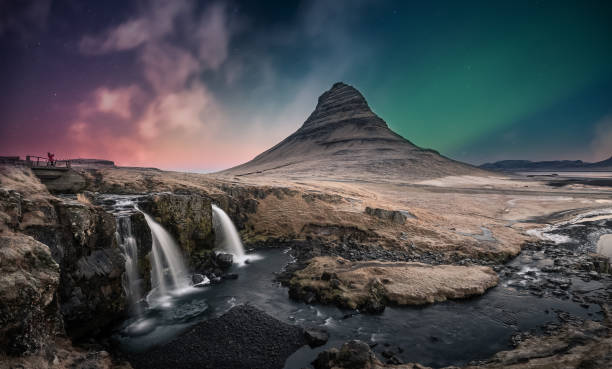 Northern lights aurora borealis over kirkjufell waterfall in Iceland Northern lights aurora borealis over kirkjufell waterfall in Iceland kirkjufell stock pictures, royalty-free photos & images