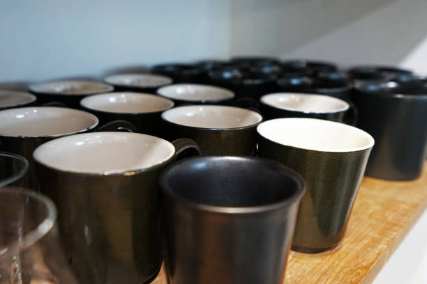 istock Close up wooden display shelf of black and white ceramic cup 1216107152