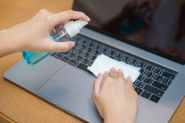 istock woman is cleaning laptop by alcohol spray 1216108498