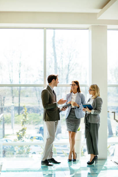 istock Business people using digital tablet in the lobby and discussing 1216109776