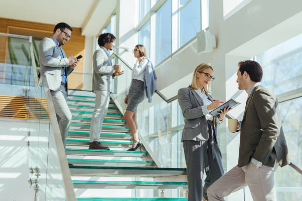 istock Two business people discussing report on stairs 1216109805