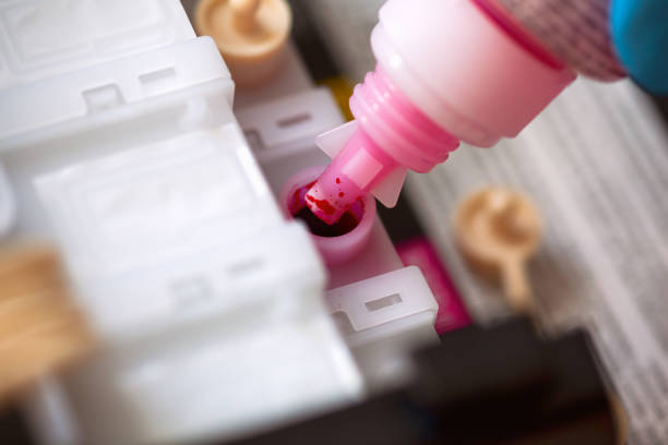 istock Bottle with magenta colour ink refilling printer cartridge 1216109929