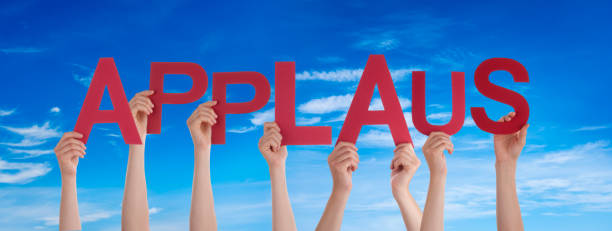 People Hands Holding Word Applause Means Applause, Blue Sky People Hands Holding Colorful German Word Applaus Means Applause. Blue Sky As Background applaus stock pictures, royalty-free photos & images