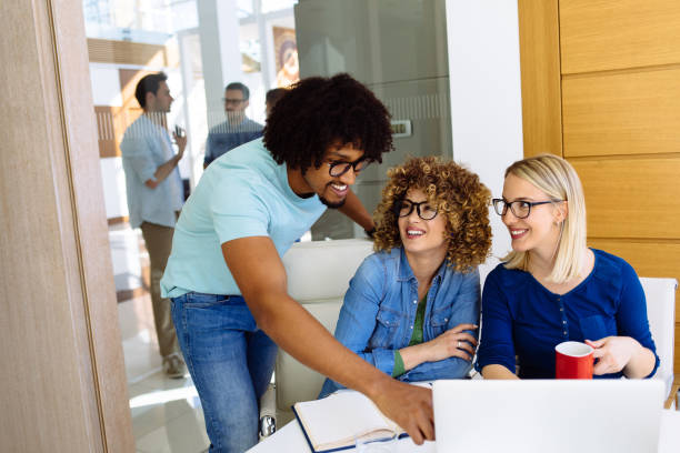 istock Confident business team working together in an office using laptop 1216110171