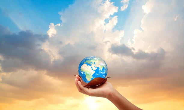 istock Hand holding the earth on dry leaf save the earth concept. sun set background. 1216110305