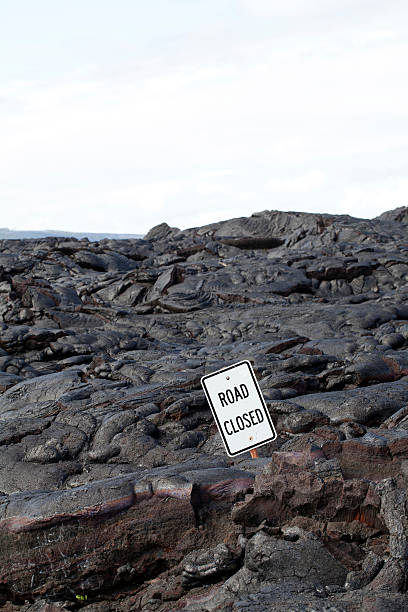 istock Road Closed sign surrounded by black lava 121611235