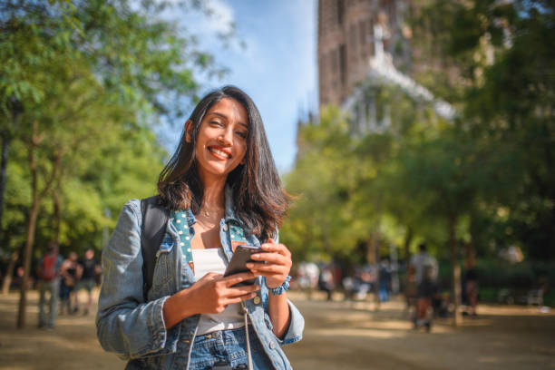 istock Relaxed Female Vacationer Using Smart Phone in Barcelona 1216113126