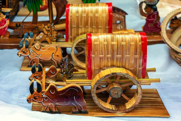 Colorful bull cart with bamboo is displayed for selling in a handicraft fair.