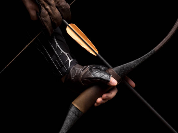 Sport arrow placed on a string of a bow on black background