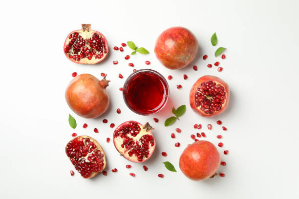 istock Flat lay with pomegranate, juice and seeds on white background 1216116542
