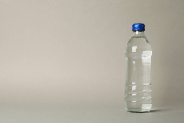 istock Bottle with water on gray background, space for text 1216117959