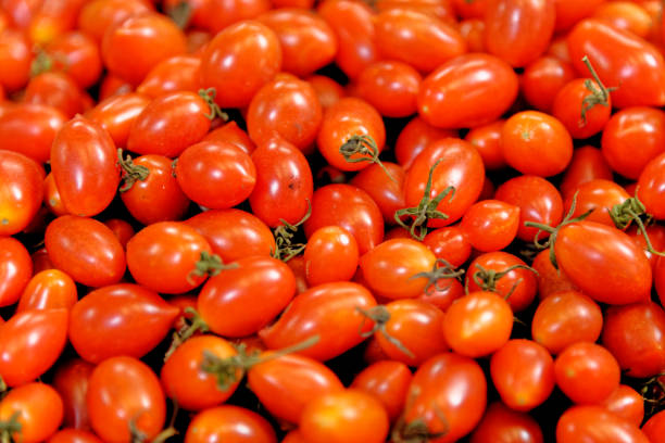 cherry tomatoes on white plate, on white background