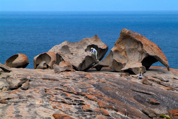 Australia, SA, Kangaroo Island, The Remarkables Kangaroo Island, Australia- February 02, 2008: Unidentified tourist climbing on rock formation The Remarkables in Flinders National Park on Kangaroo Island eagle rock stock pictures, royalty-free photos & images