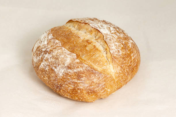 istock Fresh round white bread with a crispy crust. Pastries are Fresh, the assortment of confectionery and bakery. Closeup on a light background 1216121023