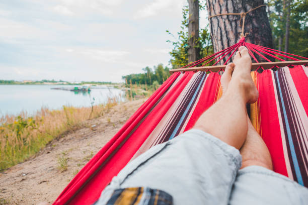 istock men legs. laying on hammock view lake view 1216123541