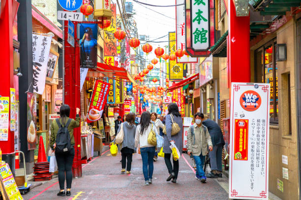 Yokohama Chinatown asian girls Yokohama, Japan - April 21, 2017: asian girls walking in Yokohama Chinatown, in pedestrian street area. the Japan's largest Chinatown. low angle street japan stock pictures, royalty-free photos & images
