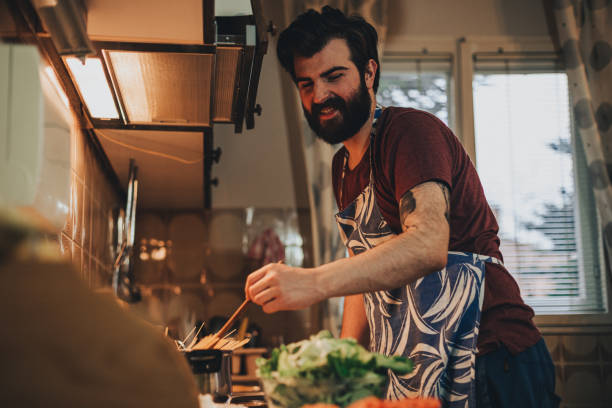 istock Young bearded man preparing healthy meal at home 1216123874