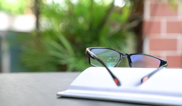 istock Reading glasses on top of open book 1216124652