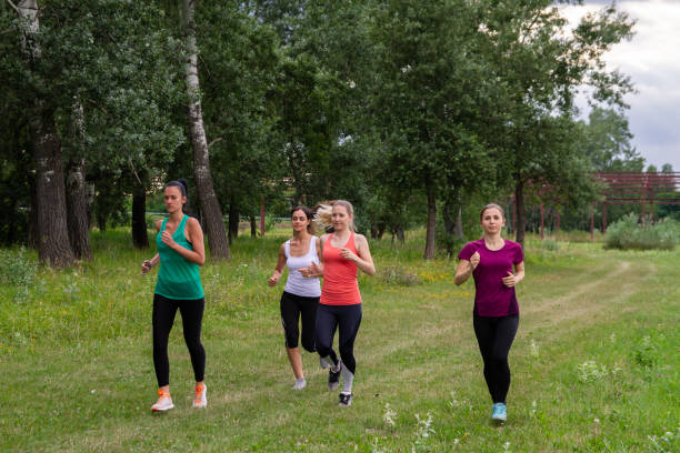 istock Group of women jogging together 1216124860