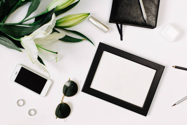 istock Blank wedding invitation cards mockups with fresh lily and black leather notebook on white backgound. Elegant modern template for branding identity. Modern design. Flat lay, top view 1216126432