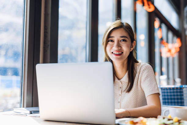 istock Asian woman working laptop at cafe. 1216128895