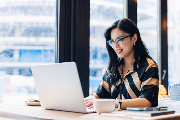 istock Asian woman working laptop at cafe. 1216128971