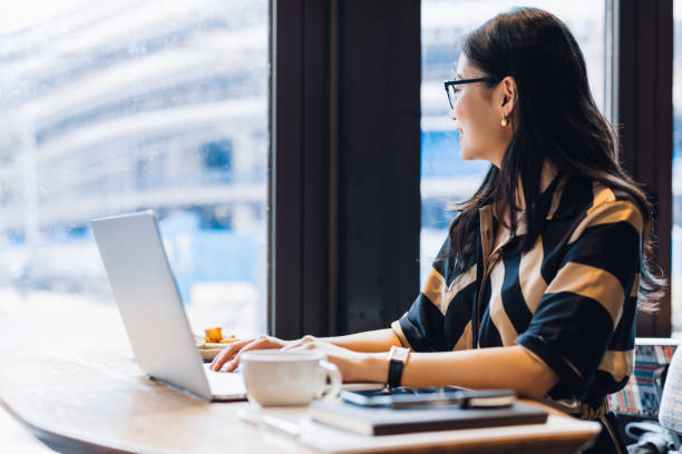 istock Asian woman working laptop at cafe. 1216128974